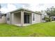 Charming house exterior featuring a covered patio and sliding glass doors at 5733 Heronpark Pl, Lithia, FL 33547