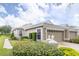 Charming home featuring a well-manicured lawn, neatly trimmed hedges, and an attached two-car garage at 5733 Heronpark Pl, Lithia, FL 33547