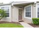 Inviting front entrance with a decorative wreath and brick walkway, flanked by lush landscaping at 5733 Heronpark Pl, Lithia, FL 33547