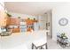 Kitchen with light wood cabinets, breakfast bar, and appliances at 5733 Heronpark Pl, Lithia, FL 33547