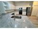 New kitchen with stainless appliances, granite countertops and white cabinetry at 5733 Heronpark Pl, Lithia, FL 33547