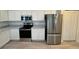 Kitchen featuring stainless appliances, modern countertops and white cabinetry at 5733 Heronpark Pl, Lithia, FL 33547