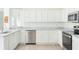 Bright kitchen featuring white cabinetry, stainless steel appliances, and a stylish countertop at 5733 Heronpark Pl, Lithia, FL 33547