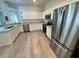 This lovely kitchen has stainless appliances, granite countertops and white cabinetry at 5733 Heronpark Pl, Lithia, FL 33547
