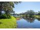 Beautiful lakefront property with mature trees and a calm waterfront at 5733 Heronpark Pl, Lithia, FL 33547
