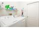 Laundry room with washer, dryer, and shelving for storage at 5733 Heronpark Pl, Lithia, FL 33547