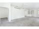 Carpeted living room featuring open doorway and bright, neutral walls and ceiling fan at 5733 Heronpark Pl, Lithia, FL 33547