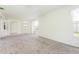 Spacious living room showcasing neutral carpet, a ceiling fan, and plentiful natural light at 5733 Heronpark Pl, Lithia, FL 33547