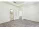 Carpeted main bedroom featuring en-suite bathroom with a view and ample closet space at 5733 Heronpark Pl, Lithia, FL 33547
