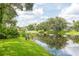 Lush backyard with water views and mature trees at 5733 Heronpark Pl, Lithia, FL 33547