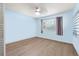 Spacious bedroom with light blue walls and wood-look floors at 6490 Cape Hatteras Ne Way # 2, St Petersburg, FL 33702