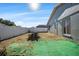 Backyard with home exterior and patchy grass at 7505 Eastmoor Ct, Tampa, FL 33615