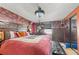 Main bedroom with king-size bed and brick accent wall at 7505 Eastmoor Ct, Tampa, FL 33615