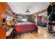 Main bedroom with a king-size bed, brick feature wall, and mirrored closet at 7505 Eastmoor Ct, Tampa, FL 33615