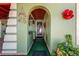 Front entry with an arched doorway, green walls, and decorative accents at 7505 Eastmoor Ct, Tampa, FL 33615