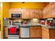 Wood kitchen cabinets, stainless steel appliances, and a tile countertop at 7505 Eastmoor Ct, Tampa, FL 33615