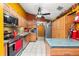 Kitchen features wood cabinets, stainless steel appliances, and a tile countertop at 7505 Eastmoor Ct, Tampa, FL 33615