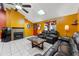 Living room features yellow walls, leather seating, and a fireplace at 7505 Eastmoor Ct, Tampa, FL 33615