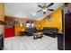 Living Room with yellow walls, leather couches, and a ceiling fan at 7505 Eastmoor Ct, Tampa, FL 33615