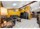 Spacious living room with yellow walls, leather sofas, and a large TV at 7505 Eastmoor Ct, Tampa, FL 33615