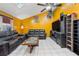 Living room with yellow walls, leather sofas, and a ceiling fan at 7505 Eastmoor Ct, Tampa, FL 33615
