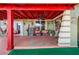 Relaxing covered patio with seating and red accents at 7505 Eastmoor Ct, Tampa, FL 33615