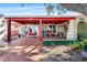 Covered patio with red accents, comfortable seating, and a relaxing hammock at 7505 Eastmoor Ct, Tampa, FL 33615