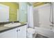 Clean bathroom with tub, shower, and a dark vanity at 7817 Water Tower Dr, Tampa, FL 33619