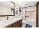 Updated bathroom with a tub, shower, and dark wood vanity at 9415 Blind Pass Rd # 601, St Pete Beach, FL 33706