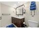 Bathroom boasts a large vanity with dark wood cabinets and a big mirror at 9415 Blind Pass Rd # 601, St Pete Beach, FL 33706