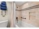 Updated bathroom with beige tile, shower/tub combo, and modern vanity at 9415 Blind Pass Rd # 601, St Pete Beach, FL 33706