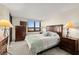 Comfortable bedroom with water views and a dresser at 9415 Blind Pass Rd # 601, St Pete Beach, FL 33706