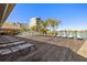 Community deck with lounge chairs overlooking the water at 9415 Blind Pass Rd # 601, St Pete Beach, FL 33706