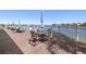 Waterfront deck with tables and chairs for outdoor dining at 9415 Blind Pass Rd # 601, St Pete Beach, FL 33706