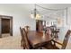 Bright dining room features a large wood table, chandelier and views to kitchen at 9415 Blind Pass Rd # 601, St Pete Beach, FL 33706