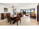 Spacious dining room with a large wood table and chandelier at 9415 Blind Pass Rd # 601, St Pete Beach, FL 33706