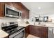 Modern kitchen with stainless steel appliances and island at 9415 Blind Pass Rd # 601, St Pete Beach, FL 33706