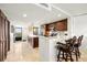 Open kitchen features dark wood cabinets, granite countertops, and breakfast bar at 9415 Blind Pass Rd # 601, St Pete Beach, FL 33706