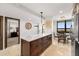 Modern kitchen with stainless steel appliances and breakfast bar at 9415 Blind Pass Rd # 601, St Pete Beach, FL 33706