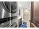 Modern laundry room with stackable washer and dryer, and a bathroom at 9415 Blind Pass Rd # 601, St Pete Beach, FL 33706