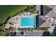 Aerial view of resort-style pool, clubhouse, and surrounding landscape at 9415 Blind Pass Rd # 601, St Pete Beach, FL 33706
