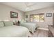 Guest bedroom with two twin beds and a view to the backyard at 102 Old Mill Pond Rd, Palm Harbor, FL 34683