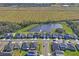 Aerial view of houses and lake at 10507 Daybreak Gln, Parrish, FL 34219