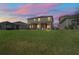 Two-story house, covered patio, and lush lawn at dusk at 10507 Daybreak Gln, Parrish, FL 34219