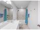 Clean bathroom with double vanity, shower/tub combo, and teal accents at 10507 Daybreak Gln, Parrish, FL 34219
