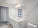 Double vanity bathroom with white cabinets and a large mirror at 10507 Daybreak Gln, Parrish, FL 34219