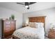 Bedroom with wood bed frame, dresser, and ceiling fan at 10507 Daybreak Gln, Parrish, FL 34219