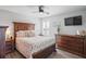 Main bedroom with wood furniture, ceiling fan, and TV at 10507 Daybreak Gln, Parrish, FL 34219