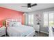 Bedroom with coral accent wall and a queen-size bed at 10507 Daybreak Gln, Parrish, FL 34219