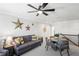 Bonus room features a sectional sofa, round table, and ceiling fan at 10507 Daybreak Gln, Parrish, FL 34219